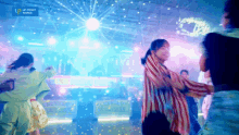 a group of people are dancing in front of a sign that says " up front works "