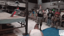 a man in a wrestling ring with a sign that says ' bc ' on the bottom right