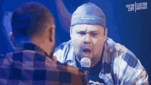 a man speaking into a microphone with youtube castro brothers written in the corner