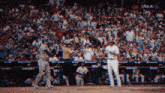 a baseball player wearing a yellow jersey with the number 60 on it stands on the field