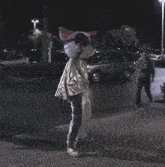 a person in a cat costume with a fire lane in the background