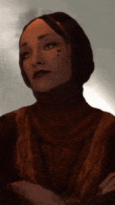 a woman with a heart tattoo on her face is wearing a turtleneck