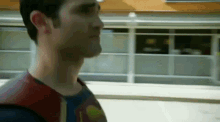a man in a superman costume is walking down a street