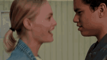 a man and a woman are hugging each other .