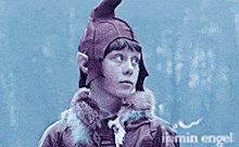 a young boy wearing a hat with ears and a jacket with the name lyda written on it
