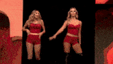 a woman in a red outfit is dancing on a stage .