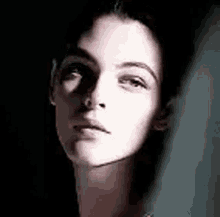 a close up of a woman 's face in the dark .