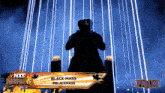 a silhouette of a man standing in front of a sign that says " black mass "