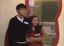 a boy and a girl are posing for a picture and the girl has a name tag that says kulette