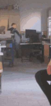 a man sits at a desk with a computer monitor