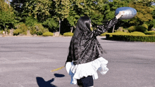a woman in a polka dot jacket is holding a balloon in her hand
