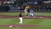 a baseball game is being played in front of a mlb.tv sign