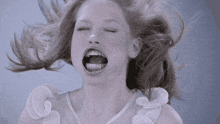 a woman in a white dress with her mouth open