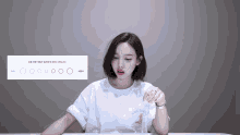 a woman sitting at a table with circles on the screen