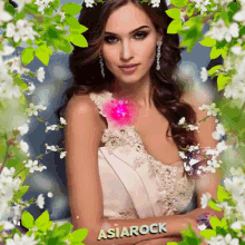 a woman in a white dress is surrounded by white flowers and green leaves and the name asiarock is on her arm