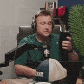 a man wearing headphones and a hat that says good enoughers