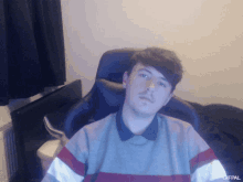 a man is sitting in a chair with a gifpal watermark on the bottom right