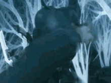 a close up of a person 's face in a dark room surrounded by a blurred background .