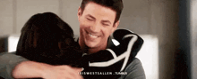 a man and a woman are hugging each other in a room .