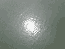 the sun is shining through the water and making a circular pattern