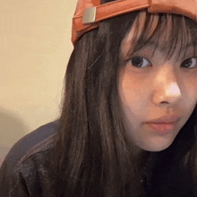 a close up of a girl wearing a hat and a jacket