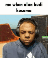 a man wearing headphones with the words me when alan budi kusuma below him