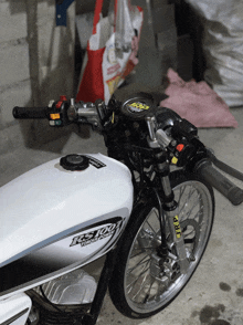 a white motorcycle with the word ks100 on the tank