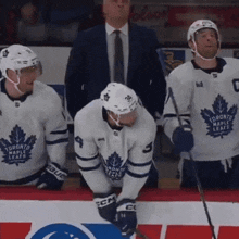 a group of toronto maple leafs hockey players are on the ice