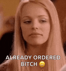 a woman with long blonde hair is making a funny face and saying `` already ordered bitch '' .
