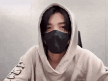a person wearing a mask and a hoodie that says nike