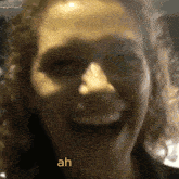 a close up of a woman 's face with the word ah written in yellow
