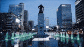 a fountain in front of a building that says samsung uhd on it