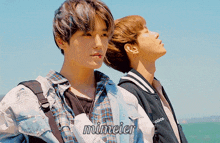 a couple of young men standing next to each other with the name mimeier written on the bottom