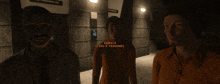 a man and two women are standing in a dark room with a sign that says robot experiment zone