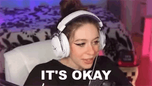 a woman wearing headphones and a microphone is sitting in a chair .