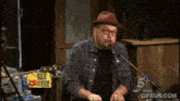 a man singing into a microphone in front of a sign that says thursdays blues