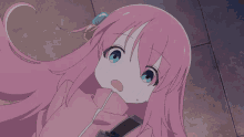 a girl with pink hair and a blue flower in her hair