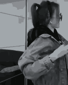 a black and white photo of a girl wearing headphones
