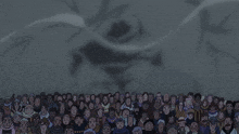 a crowd of people are watching a cartoon character