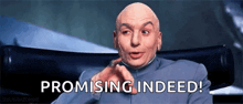 a bald man is sitting in a chair and promising indeed