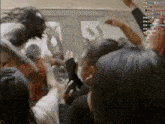 a group of people are gathered in a room with their hands in the air and a sign that says willow on the bottom