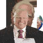 a man in a suit and tie is smiling in front of a white background