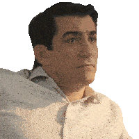 a man wearing a plaid shirt looks to his left