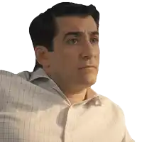 a man wearing a plaid shirt looks to his left