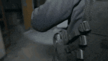 a man is holding a flashlight in a dark room .