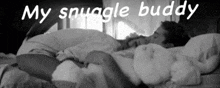 a couple laying in bed with the words my snuggle buddy written above them