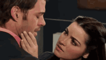 a man and a woman are looking at each other