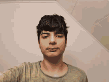 a young man is taking a selfie in a square .