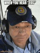a man wearing headphones and a hat with a patch on it .