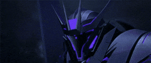 a close up of a robot with purple lights on it 's head and arms .